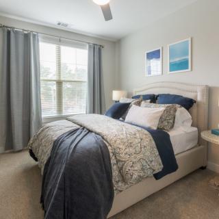 A cozy bedroom with stylish decor and natural light.