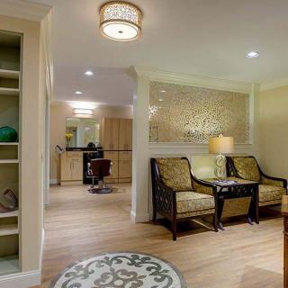 A cozy living room with elegant seating and warm lighting.