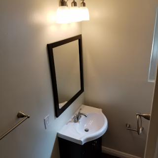 A modern bathroom featuring a sleek sink and mirror.