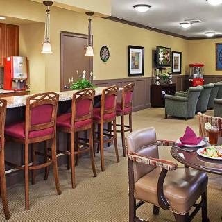 A cozy dining area with red bar stools and comfortable seating.