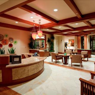 A modern reception area with stylish furniture and warm lighting.