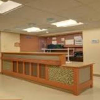A modern reception desk in a well-lit office environment.