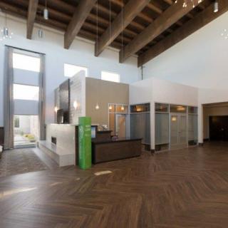 Modern lobby with high ceilings and a reception desk.