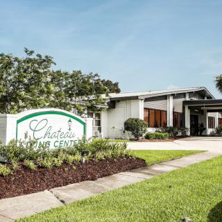 Chateau Living Center entrance with well-maintained landscaping.