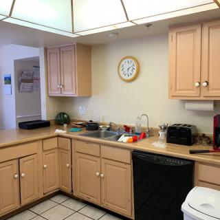 A well-organized kitchen with wooden cabinets and various appliances.