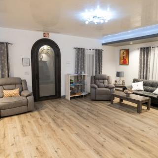 A modern living room featuring comfortable sofas, wooden flooring, and stylish decor.