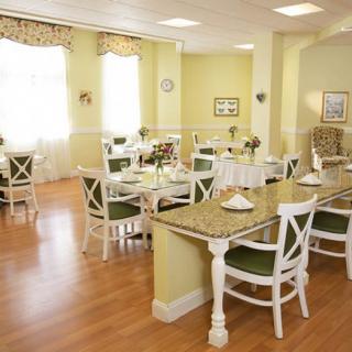 A bright and inviting dining room with neatly arranged tables and chairs.