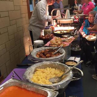 A vibrant buffet setup with a variety of dishes served at a community event.