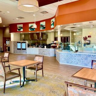 A modern restaurant interior with seating and a visible counter area.