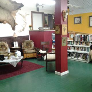 A cozy reading nook with bookshelves and comfortable seating.