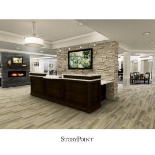 A modern reception area with a central stone wall and wood flooring, featuring stylish lighting and seating.