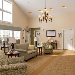 A cozy living room with comfortable seating and a chandelier.