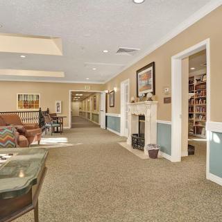 A cozy and spacious living area with a fireplace, featuring comfortable furniture and elegant decor.