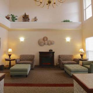A cozy lobby with comfortable seating and warm lighting.