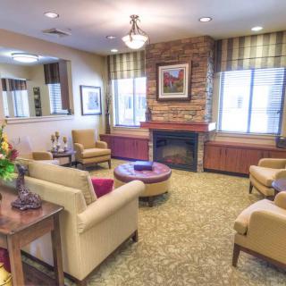 A cozy living room with comfortable armchairs and a fireplace.