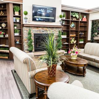 A cozy living room with elegant furniture and a warm fireplace.
