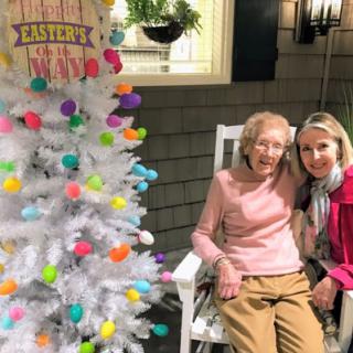 A joyful moment celebrating Easter with family, featuring a beautifully decorated white tree.