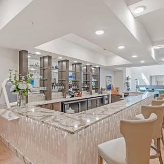 A stylish modern bar area with elegant seating and contemporary decor.