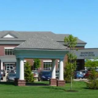 A healthcare clinic building with a well-maintained outdoor area.