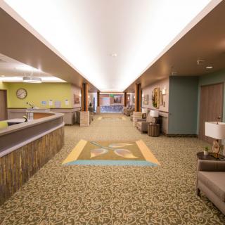 A well-lit lobby area with a reception desk and seating.