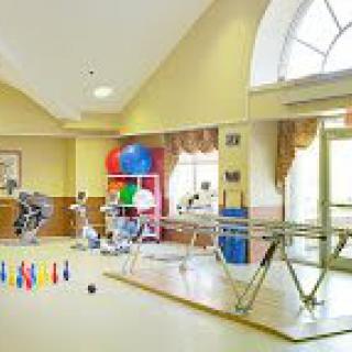 A well-equipped physical therapy room with exercise machines and rehabilitation tools.
