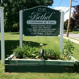 A sign for Bethel Christian Center is displayed outdoors, surrounded by greenery.