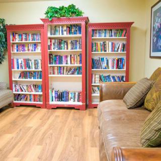 Cozy reading space with bookshelves and a comfortable sofa.