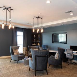 A modern living room with comfortable seating and elegant chandeliers.