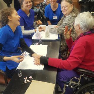 Caregivers and elderly individuals engaging in a joyful activity together.