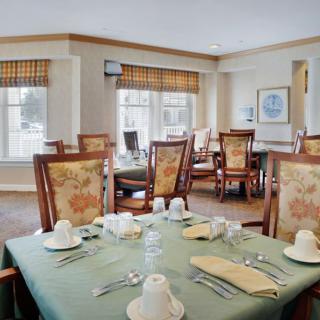A well-arranged dining room with elegantly set tables and comfortable chairs.