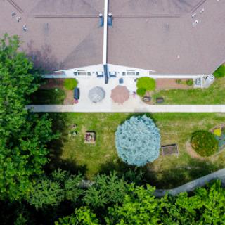 An aerial view of a well-maintained garden featuring various seating arrangements and lush greenery.