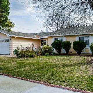 A suburban house with a well-maintained front yard and garage.