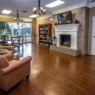A cozy living room with a fireplace, hardwood floors, and comfortable seating.