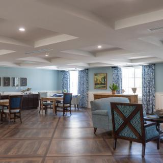 Spacious and elegantly designed living room with comfortable seating and natural lighting.