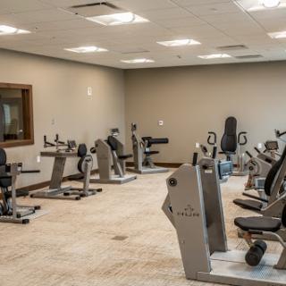 An interior view of a modern gym featuring various exercise machines.