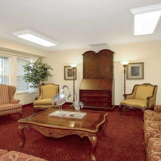 A cozy living room with classic furniture and warm lighting.