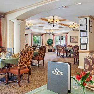 An elegant restaurant dining room with neatly arranged tables and chairs.