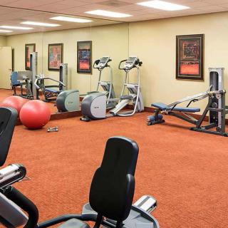 A well-equipped gym with various exercise machines and fitness equipment.