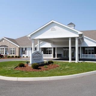 A welcoming residential community center with a well-maintained front entrance and landscaped grounds.