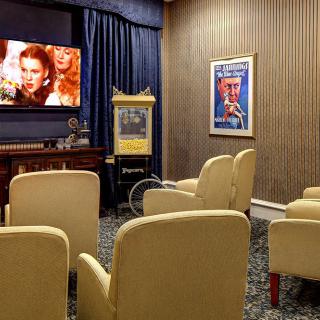 A cozy home theater setup with comfortable seating and classic movie posters.