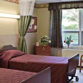 A cozy room with two single beds, decorated with flowers and curtains.