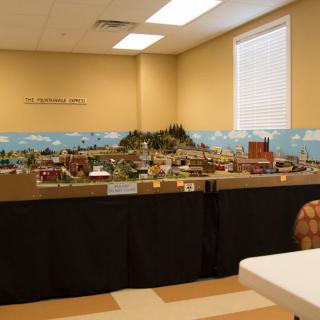 A detailed model train layout displayed in an indoor setting.