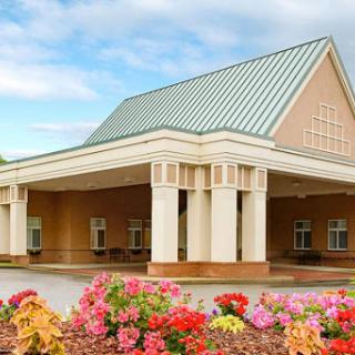 A welcoming entrance featuring a beautifully landscaped area with vibrant flowers.