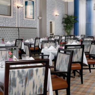 An elegant restaurant dining area with neatly set tables and chairs.
