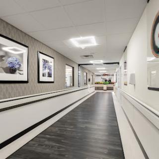 A well-lit and modern hallway featuring decorative artwork and sleek design.