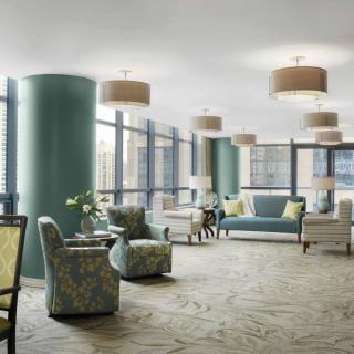 A modern lounge area with comfortable seating and large windows.
