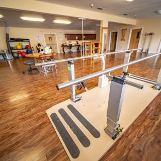 A well-equipped rehabilitation center featuring parallel bars for physical therapy exercises.