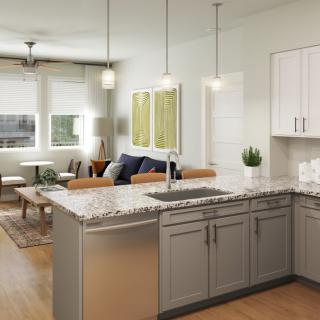 Modern open-concept kitchen and living area with a stylish kitchen island and pendant lighting.
