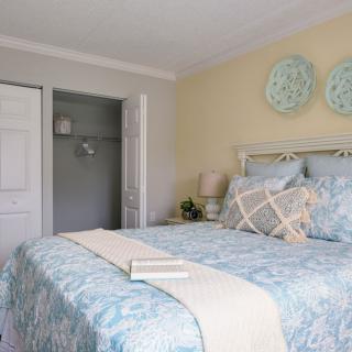 A cozy bedroom with soft, neutral-colored decor and a neatly made bed.
