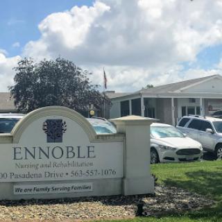 A view of the Ennoble residential facility with a cloudy sky in the background.